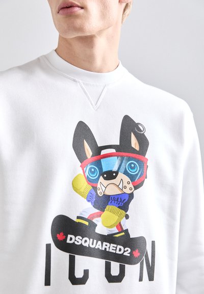 White sweatshirt features a cartoon dog wearing goggles and gloves, standing on a snowboard with "DSQUARED2 ICON" printed below.