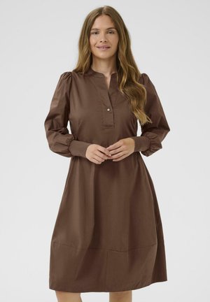 Brown cotton dress with a collared neckline, button detail, long puff sleeves, and a relaxed silhouette, featuring a hemline above the knee.