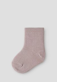 Rosa Socke in Strick mit einem gerippten Bund, weicher Textur und leicht tailliertem Schnitt, entworfen für Komfort und den täglichen Gebrauch.