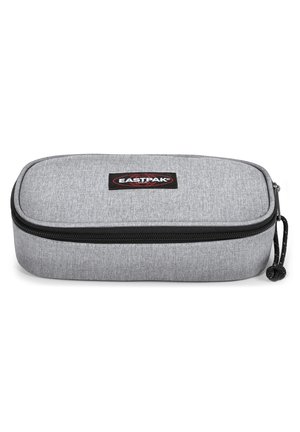 Gray fabric zippered pencil case with rounded edges, black zipper, and black cord pull. Features a small Eastpak logo on the front.