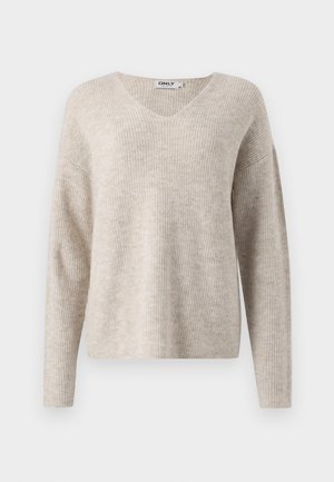 Beige gebreide trui met een V-hals, lange mouwen en een relaxte pasvorm. Kenmerkt zich door een gestructureerd ribpatroon. Merklabel zichtbaar binnen de halslijn.
