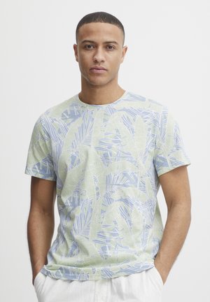 Short-sleeve t-shirt made of lightweight fabric, featuring a blue and green leaf-patterned design with a round neckline.