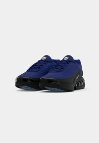 Navy-blue athletic shoes with a textured upper, black rubber soles, and a distinctive lacing system. Features air cushioning accents.