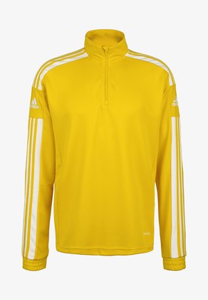Pull-over de sport jaune avec un col zippé à moitié, des rayures blanches sur les côtés, des poignets côtelés et un logo brodé sur la manche gauche.