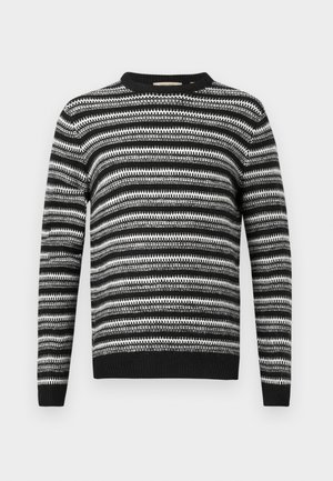 Mustavalkoinen raidallinen neulepaita, jossa on pyöreä pääntie ja pitkät hihat. Sisältää teksturoitua kuviota kauttaaltaan sekä resorit hihoissa ja vyötäröllä.