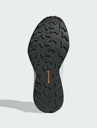 Suola di scarpa in gomma nera con un disegno del battistrada aggressivo, caratterizzata da una superficie testurizzata e un logo Continental prominente in arancione.