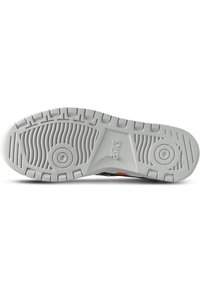 White rubber shoe sole with textured grip, circular accents, and a wave pattern. Features raised areas for traction and cushioning.