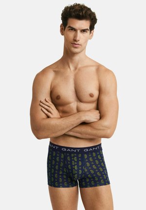 Navy blue boxer briefs with a paisley pattern in green and yellow. Features a solid waistband with "GANT" branding. Soft fabric texture.