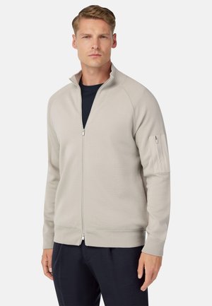 Hellgrauer Reißverschluss-Sweatshirt mit hohem Kragen, gerippten Bündchen und einer Reißverschlusstasche am linken Arm. Weicher Stoff und lässige Passform.