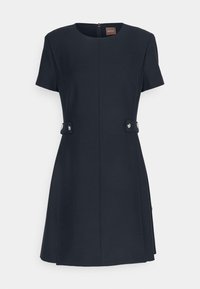 Kortärmad marinblå klänning med rund halsringning, dragkedja bak och knappdetaljer på sidorna. Slät textur med en utsvängd silhuett.