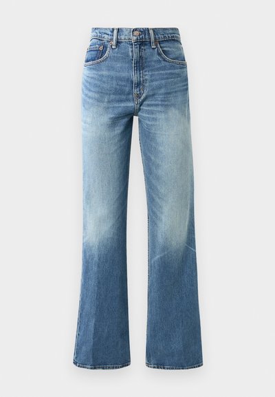 Ljust blå högmidjade jeans med vida ben, blekt utseende, fem fickor och metallknappstängning.