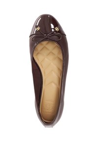Brown patent leather flats with a rounded toe, gold accents, and a small bow. Textured insole features a geometric pattern.