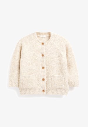 Cardigan en tricot duveteux de couleur crème avec cinq boutons en bois et deux poches avant, manches longues et bords côtelés.
