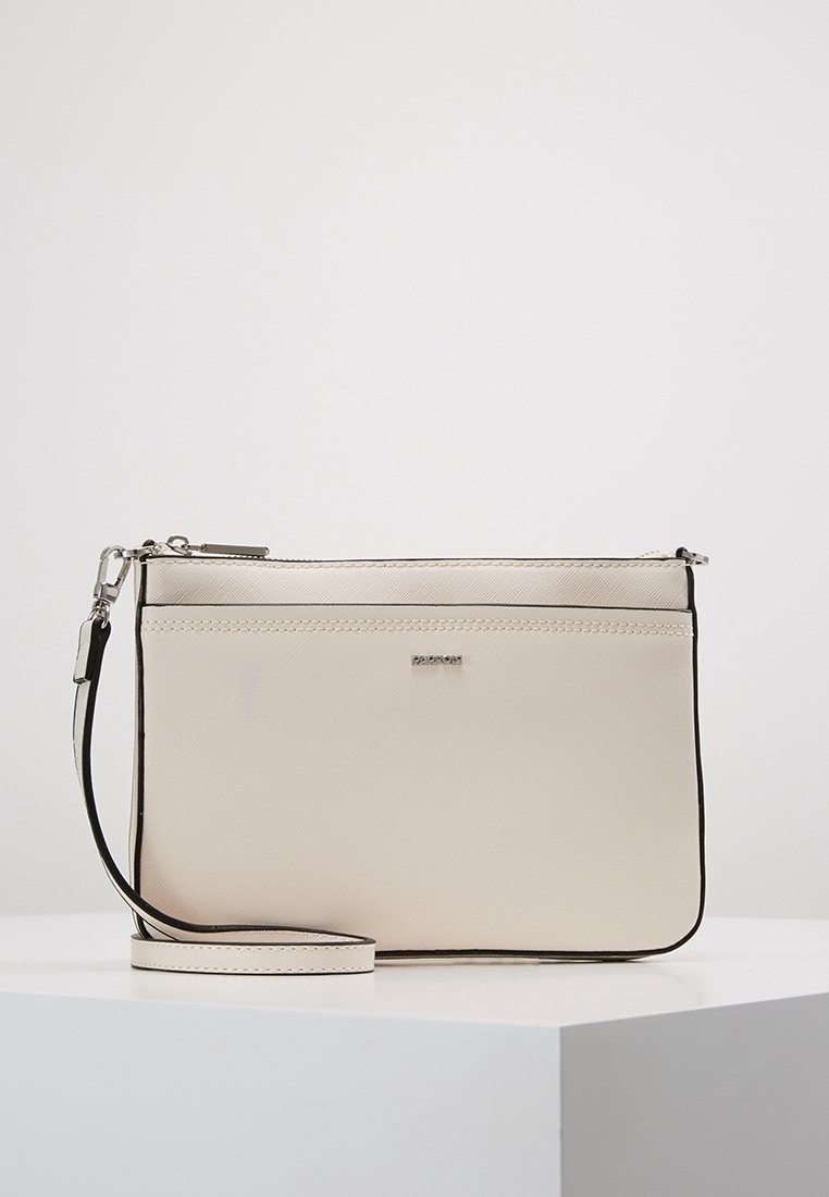 Beige crossbody taška vyrobená z texturovaného syntetického materiálu se stříbrným zipovým uzávěrem a kontrastní černou obšívkou. Obsahuje odnímatelný popruh.