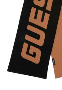 Écharpe tricotée présentant un schéma de couleurs audacieux en noir et beige, avec le mot "GUESS" affiché en grandes lettres. Texture lisse et forme rectangulaire.
