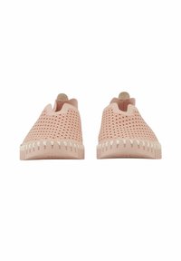 Pink slip-on shoes with a perforated design, rounded toe, and white stitching around the sole. Smooth texture and minimalistic shape.