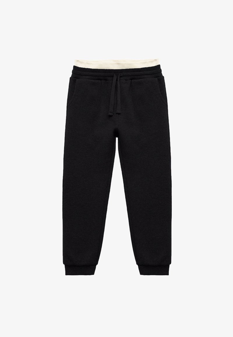 Schwarze Jogginghose aus strukturiertem Stoff, mit weißem Kordelzug am Bund und elastischen Bündchen; mit Seitentaschen.