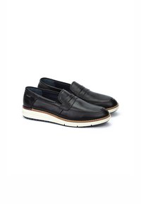 Zapatos de piel negra sin cordones con un diseño de mocasín, que cuentan con una suela beige en contraste y un detalle de costura decorativa en la parte superior.