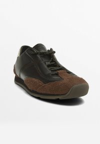 Leather and suede sneaker, primarily dark brown with a textured brown suede toe. Features dark laces and a rubber sole. Rounded design.