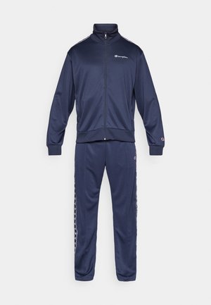 Navy track suit made of smooth fabric, featuring a zip-up jacket with high collar and matching pants, both with stripe accents along the sides.
