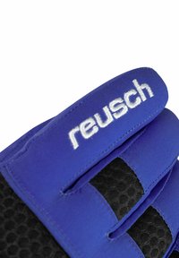 Close-up of blue goalkeeper glove fingers with black textured grip and white "reusch" logo embroidered on top finger.