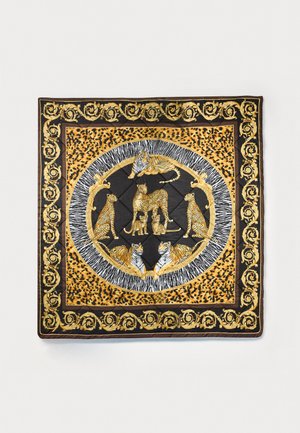Colcha con un fondo negro y acentos de color dorado y estampado de leopardo. El diseño central incluye animales estilizados: tigres y leopardos.