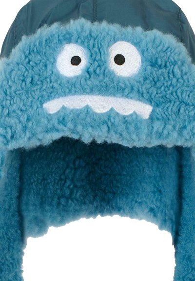 Cappello in pile blu per l'inverno con un esterno morbido, faccia di cartone di un mostro, grandi occhi bianchi e un sorriso bianco con denti a vista. Include dei lunghi alette per le orecchie.