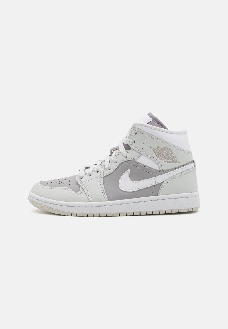 Mid-top sneakers with grey and white leather panels, perforated toe, white swoosh logo, gray accents, and white midsole.