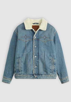 Denim jacket in light blue with a fleece-lined collar, snap fasteners, front pockets, and embroidered design near the chest.