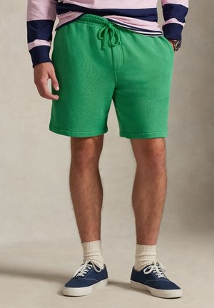 Pantaloni scurți verzi din bumbac, cu talie elastică și șnur. Au o textură fină și croială dreaptă, terminându-se deasupra genunchiului.