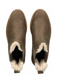 Braune Lederstiefeletten mit weichem Fellfutter und abgerundeter Zehenpartie. Verfügt über eine Steppnaht um die Sohle und eine Schlaufe für ein einfaches Anziehen.