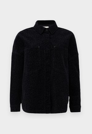 Black leopard print shirt jacket featuring a collared neckline, button closure, and two chest pockets. Soft fabric with a textured finish.