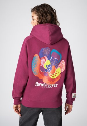 Wijnrode hoodie met een grote afbeelding van kleurrijke, abstracte bloemvormen en de tekst "flower lover" op de achterkant. Zachte stoftextuur.