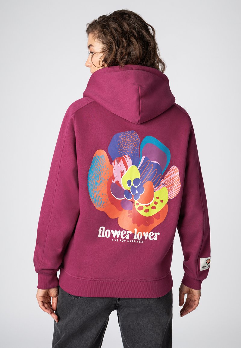 Wijnrode hoodie met een grote afbeelding van kleurrijke, abstracte bloemvormen en de tekst "flower lover" op de achterkant. Zachte stoftextuur.