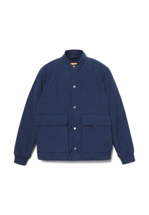 Chaqueta acolchada azul marino con cuello alzado, cierre de botones a presión y dos grandes bolsillos frontales; superficie texturizada con un patrón de diamantes.