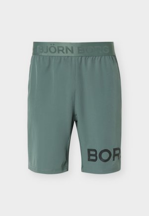 Zaļas sporta šorti ar elastīgu jostasvietu, uz kuras ir uzraksts "BJÖRN BORG" un melns "BORG" uzraksts apakšējā kreisajā kājā.