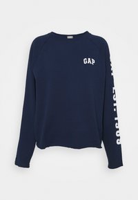 Sweatshirt bleu marine avec le logo "GAP" blanc sur la poitrine et la manche. Présente une coupe décontractée et une texture douce, avec des manches raglan.