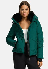 Green puffer jacket with a zip front, black faux fur-lined hood, diagonal quilted design, and side pockets. Fabric is smooth, slightly glossy.