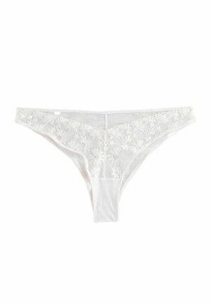 Valge pitsist string aluspüks, millel on lilleline tikand ees, pehme materjal ning minimalistik disain sujuva viimistlusega.