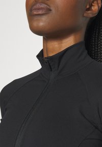 Nebbia NEBBIA WOMEN'S ZIP-UP JACKET INTENSE WARM-UP - Treningsjakke - black/gold
