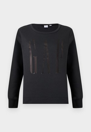 Sweat-shirt noir à manches longues avec col rond, portant discrètement les lettres brillantes "GAP" sur la poitrine, avec poignets et ourlet côtelés.