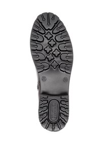 Black rubber shoe sole featuring a textured tread pattern with multiple geometric shapes and the brand "remonte" embossed near the heel.