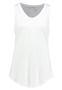 Top senza maniche bianco con scollatura a V, realizzato in tessuto morbido, dotato di un orlo curvo e un design minimalista.