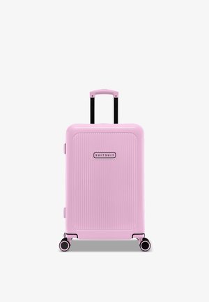 Hard-shell pink suitcase with vertical ribbed texture, black retractable handle, and dual wheels with contrasting accents.