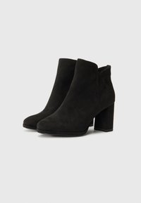 Black suede ankle boots with a block heel and rounded toe. The design features a smooth texture and a minimalistic cut around the ankle.