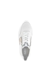 White sneaker with leather upper, lace-up closure, silver accents, and a side zipper. Features a textured beige panel and rounded toe.