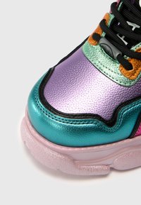 Wielokolorowe sneaker wykonane z fioletowej, turkusowej i różowej syntetycznej cholewki z teksturowanym wykończeniem oraz czarnymi sznurówkami dla dodatkowego wykończenia.