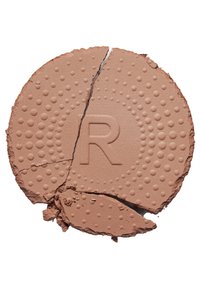 Runder, hellbrauner Makeuppuder mit strukturierten Oberflächen und eingeprägtem 'R'-Logo, zeigt Risse und unregelmäßige Kanten.
