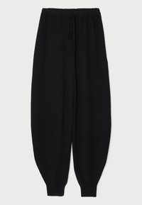 Pantalon de survêtement noir en maille, fuselé, avec taille élastique et cordon de serrage, doté de poignets côtelés aux chevilles.