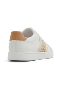 White leather sneaker with a tan accent at the heel, featuring a textured beige stripe pattern along the side, and white rubber sole.